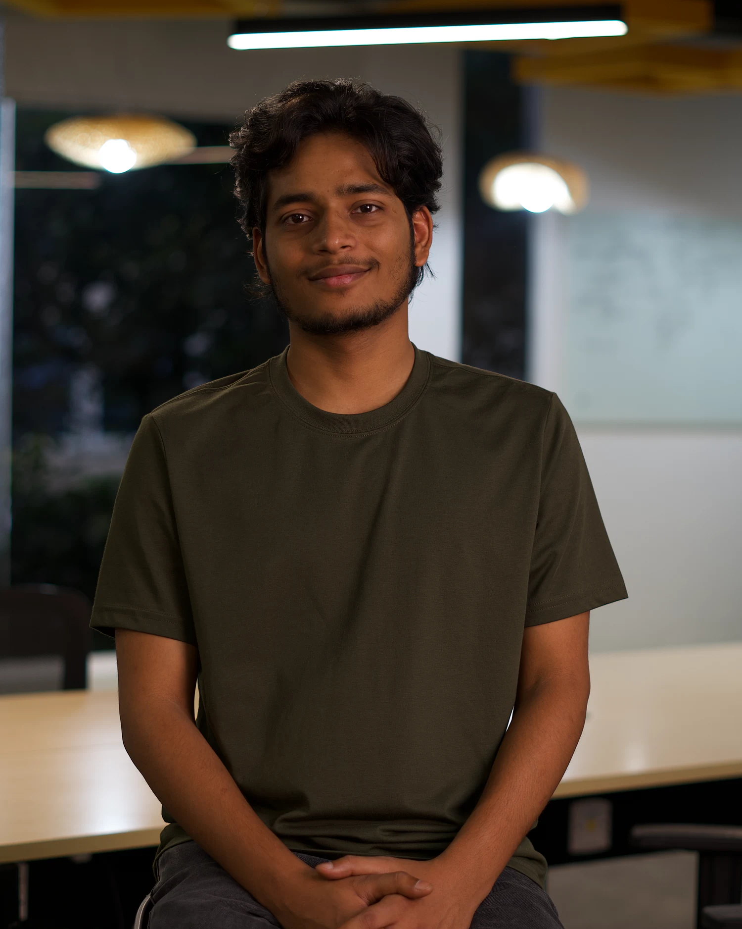 Ayush Tripathi, seated in an office.
