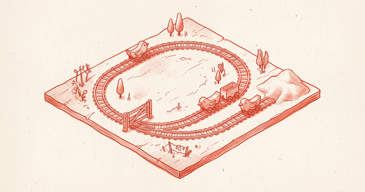 A looping toy railway whose carriages are carved birds, with a gate closed across the loop and one carriage resting in a sand-filled siding.